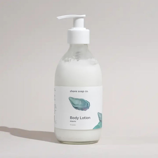 Atlantic Body Lotion with Glass Pump and Oyster Shell Design Styled in Soft Natural Light, Coastal Bath and Body Product
