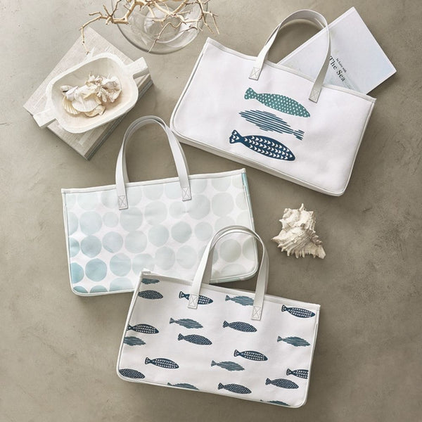 Large canvas tote with blue coastal fish pattern styled with coastal décor and books