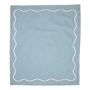 Blue cotton napkin with white embroidered scalloped border.