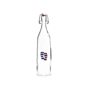 Clear glass bottle with blue and white jeweled embellishment evoking seaside charm.