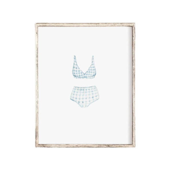 Watercolor art print of a vintage blue gingham swimsuit, evoking coastal nostalgia and seaside charm, unframed with chipboard backing, ready to gift or display.