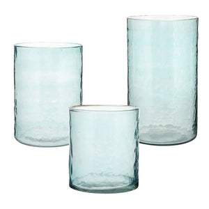 Blue hammered glass hurricane candle holders with candles
