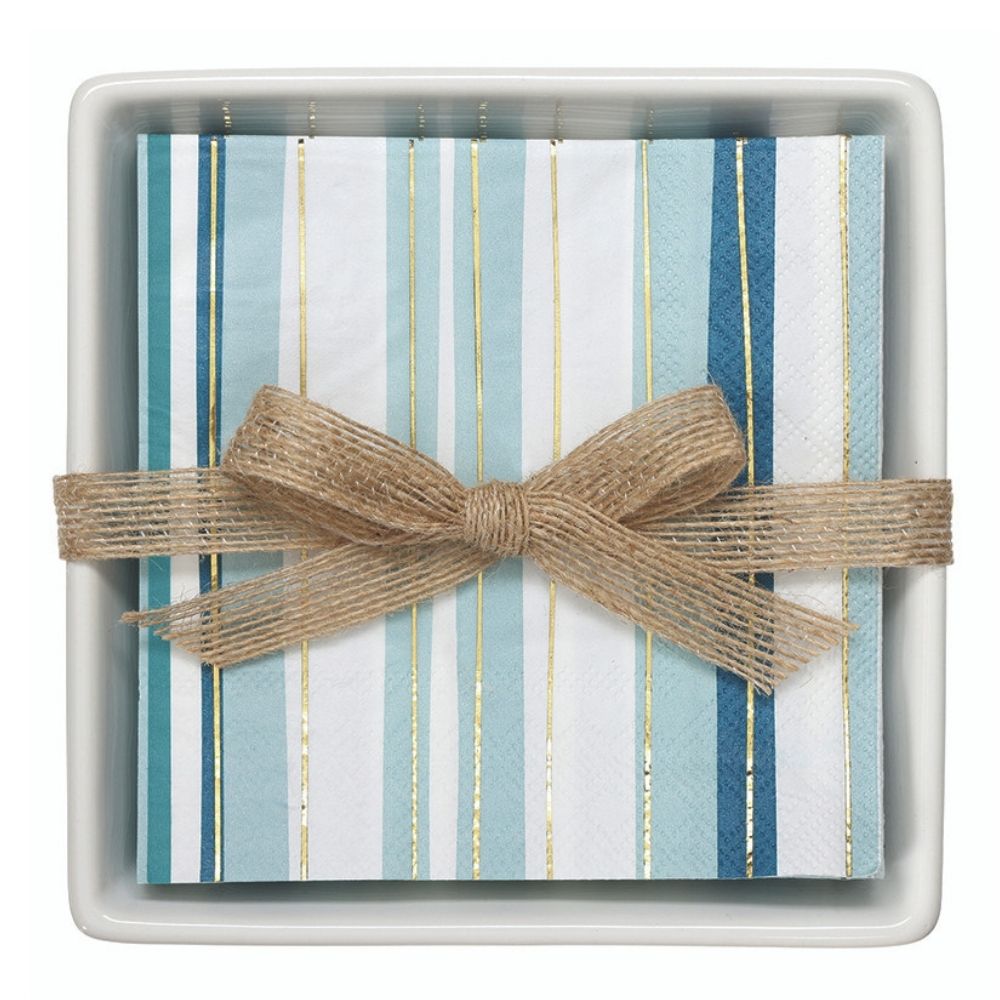 Coastal napkin gift set with blue striped paper napkins in a white ceramic tray tied with burlap ribbon