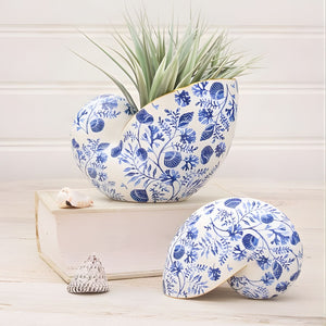 Chinoiserie shell decor with coral motifs styled on shelf with greenery