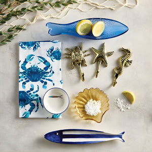 Nautical blue and white fish dish styled on coastal table setting