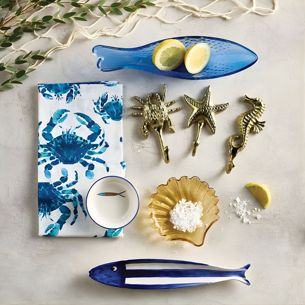 Nautical blue and white fish dish styled on coastal table setting