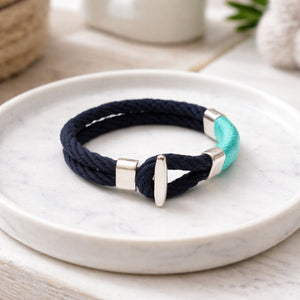 Soft cotton rope bracelet inspired by the coast, featuring silver-plated clasp and decorative bead.