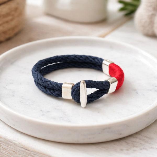 Handmade coastal cotton rope bracelet with silver-plated clasp and bead, easy to wear alone or layered.