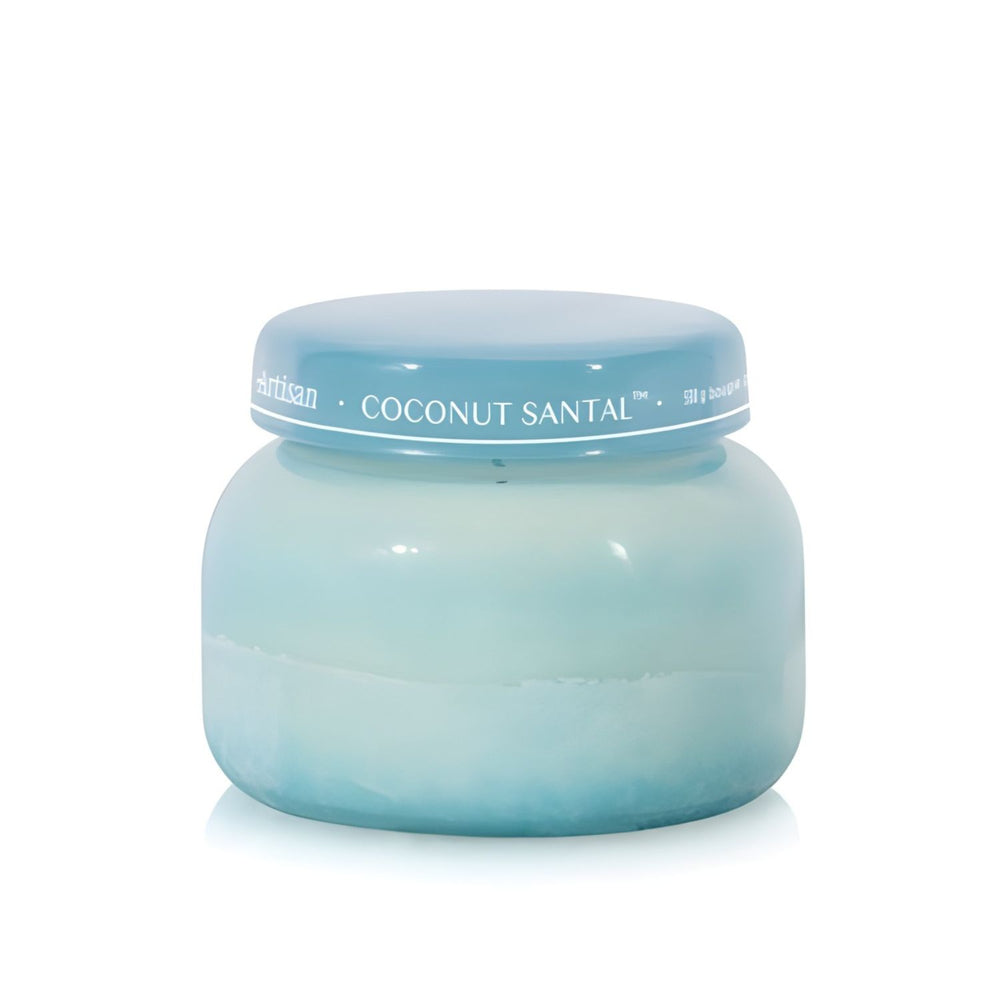 Soy-blend Coconut Santal wax candle with coconut, amber, lime, and hibiscus notes, poured in a light teal glass jar, 19 oz.