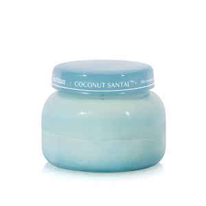 Soy-blend Coconut Santal wax candle with coconut, amber, lime, and hibiscus notes, poured in a light teal glass jar, 19 oz.