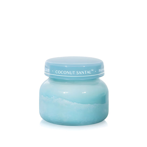 Soy-blend Coconut Santal wax candle with coconut, amber, lime, and hibiscus notes, poured in a light teal glass jar, 8oz.