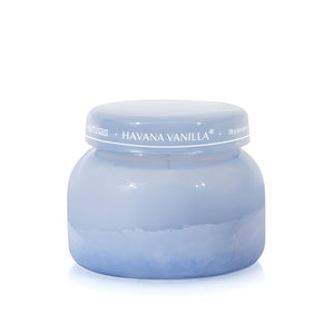 Soy-blend Havana Vanilla wax candle with vanilla, tobacco, bergamot, and sandalwood notes in a periwinkle blue glass jar, 19 oz.