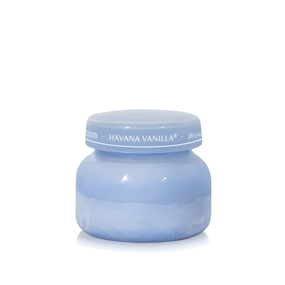 Soy-blend Havana Vanilla wax candle with vanilla, tobacco, bergamot, and sandalwood notes in a periwinkle blue glass jar, 19 oz.