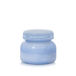 Soy-blend Havana Vanilla wax candle with vanilla, tobacco, bergamot, and sandalwood notes in a periwinkle blue glass jar, 8oz.