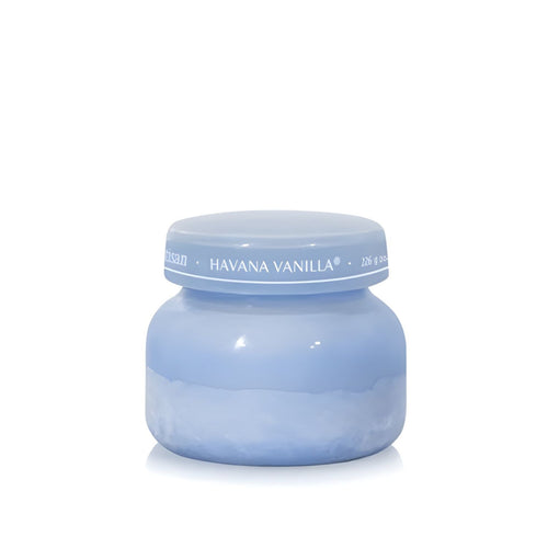 Soy-blend Havana Vanilla wax candle with vanilla, tobacco, bergamot, and sandalwood notes in a periwinkle blue glass jar, 8oz.