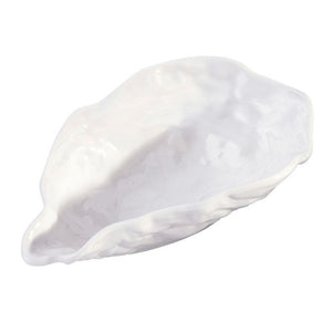 Angled view of white ceramic oyster bowl with sculpted shell shape