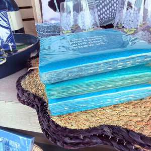 Blue and teal cocktail napkins with funny sayings on display 