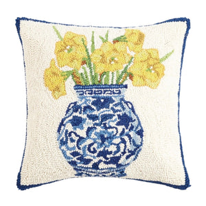 A square 16 x 16 hand-hooked wool pillow featuring a blue-and-white patterned ginger jar filled with bright yellow daffodils on a cream background.