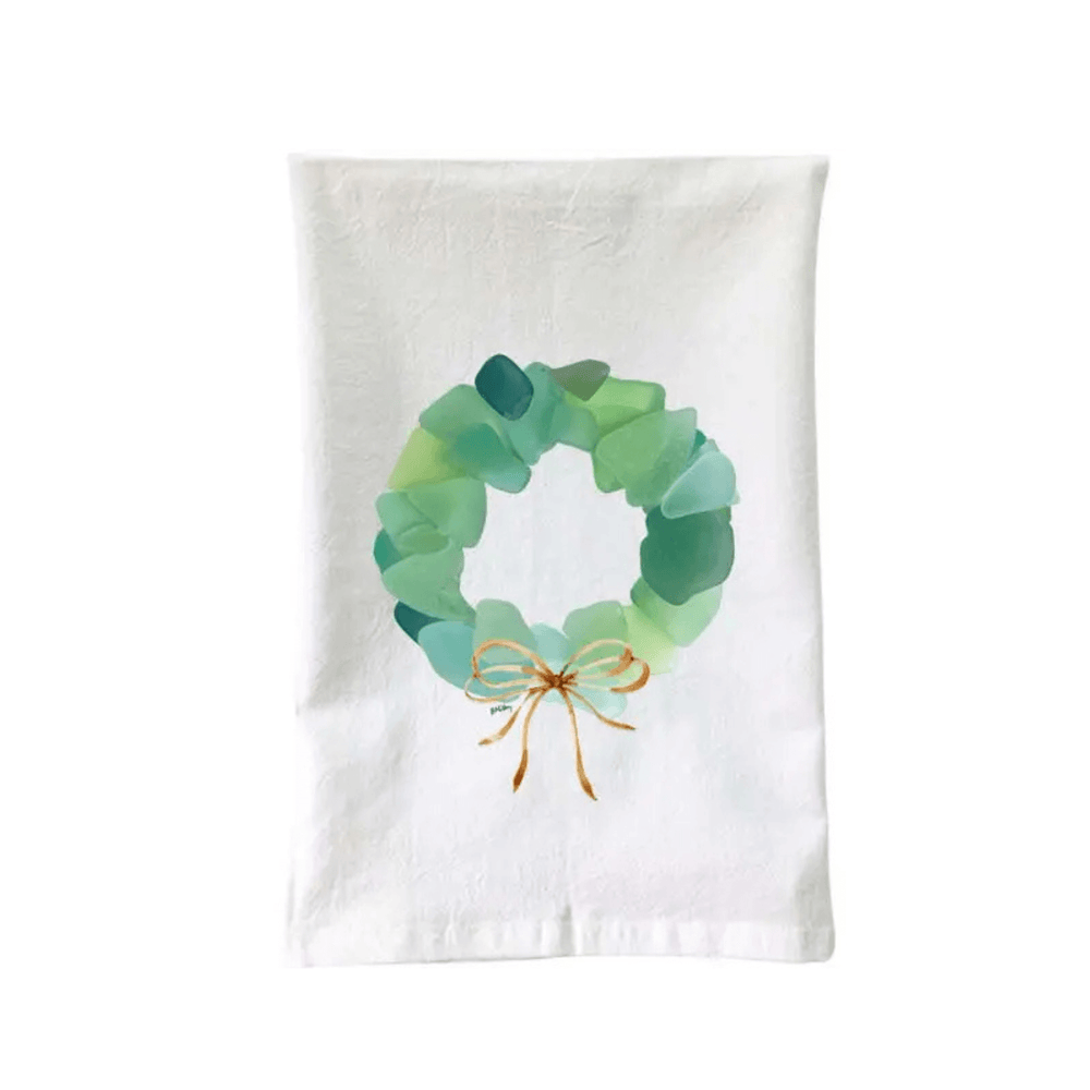 Coastal-themed flour sack towel with
sea glass wreath design and soft cotton material