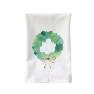 Coastal-themed flour sack towel with
sea glass wreath design and soft cotton material