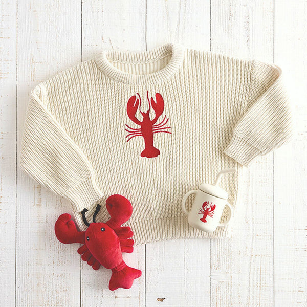 Lobster baby sweater styled with matching lobster sippy cup and plush toy