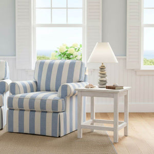 Handcrafted stacked stone lamp made from natural ocean and river stones, featuring a parchment shade and brass switch