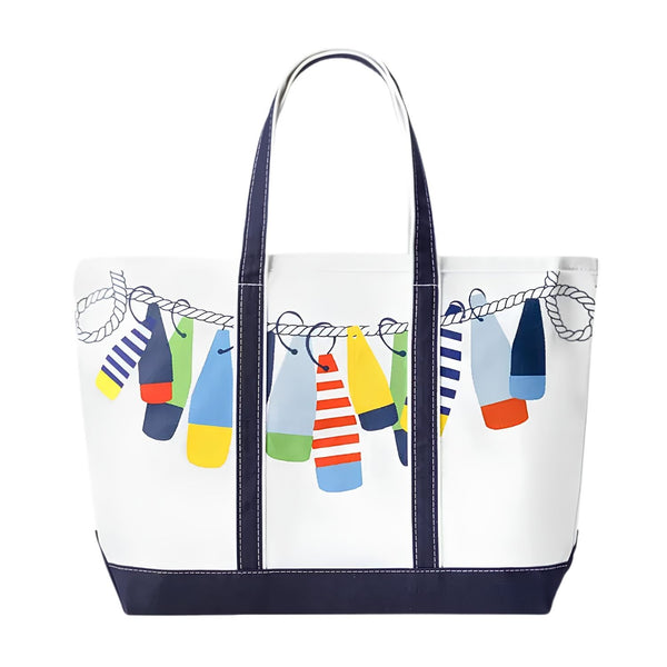 Front view of a white canvas tote bag with navy blue handles and base, featuring a colorful print of various nautical buoys hanging from a rope.