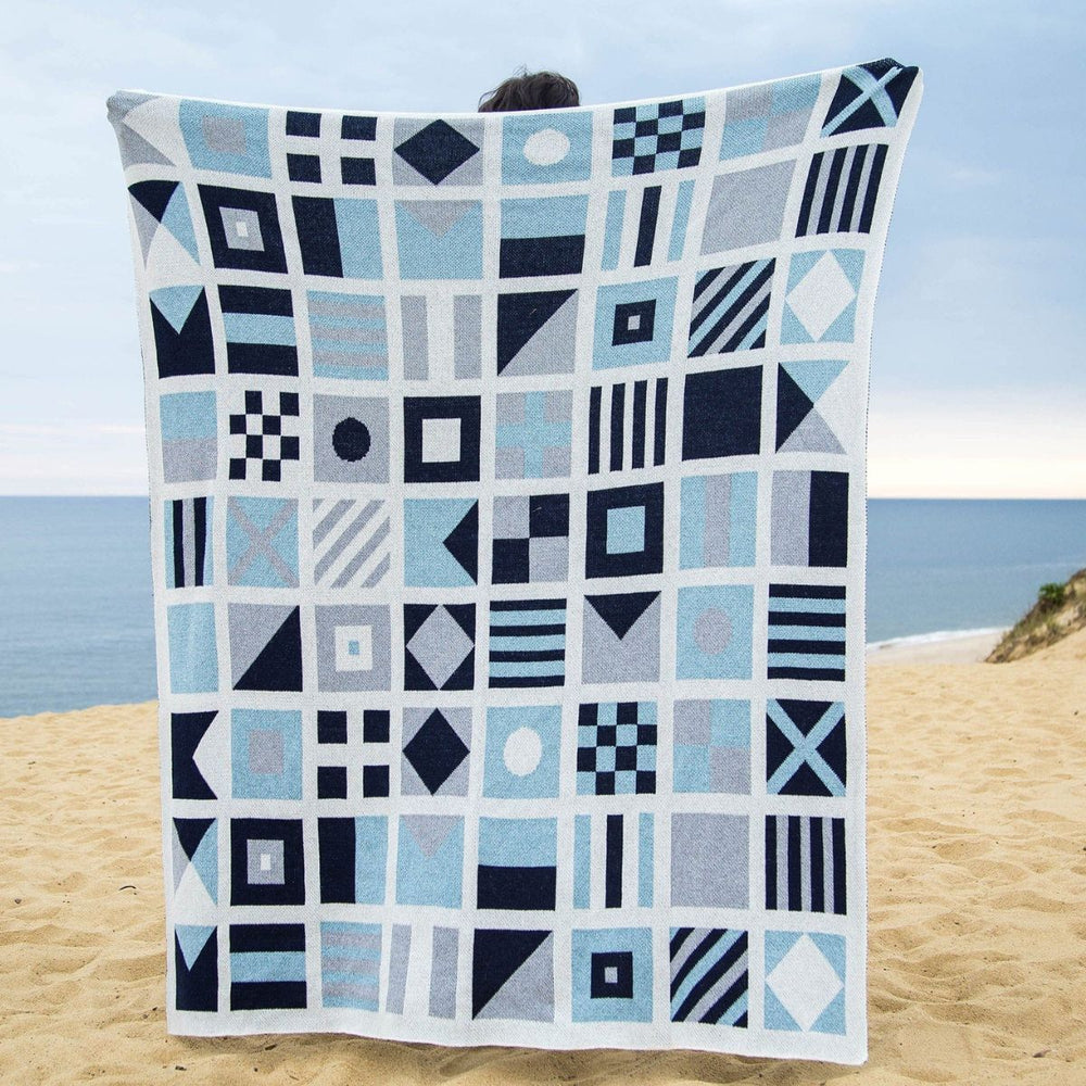 Eco Nautical Flag throw blanket featuring colorful maritime signal flags, perfect for coastal living, sailing trips, or beach days.