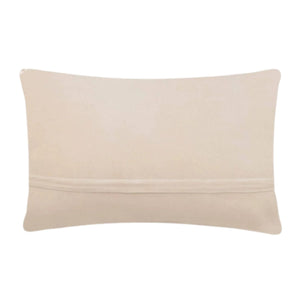 The reverse side of a lumbar pillow showing smooth cream-colored polyester velvet fabric and a hidden horizontal zipper closure