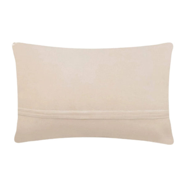 The reverse side of a lumbar pillow showing smooth cream-colored polyester velvet fabric and a hidden horizontal zipper closure