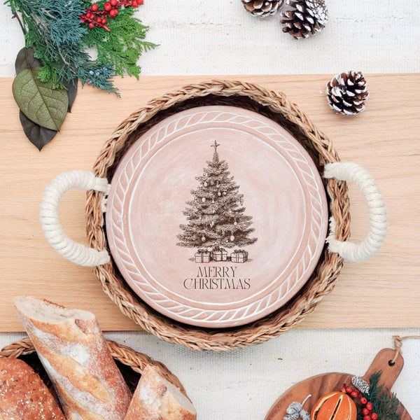 Christmas table bread warmer with engraved Merry Christmas design and rope-handled basket.
