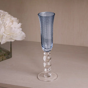 Coastal-inspired blue champagne flutes with woven swirl glass design, perfect for celebrations by the sea.