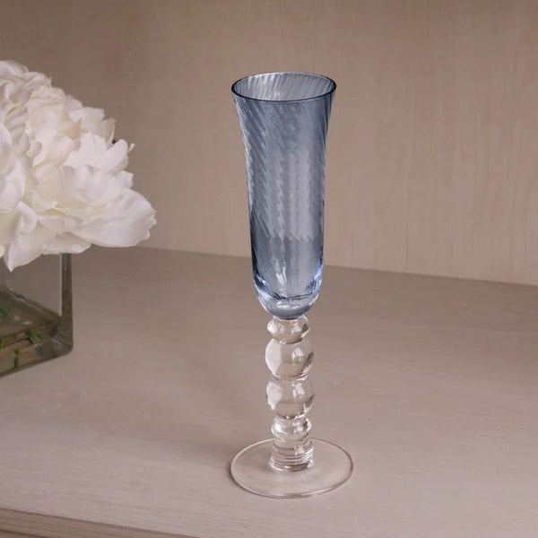 Coastal-inspired blue champagne flutes with woven swirl glass design, perfect for celebrations by the sea.