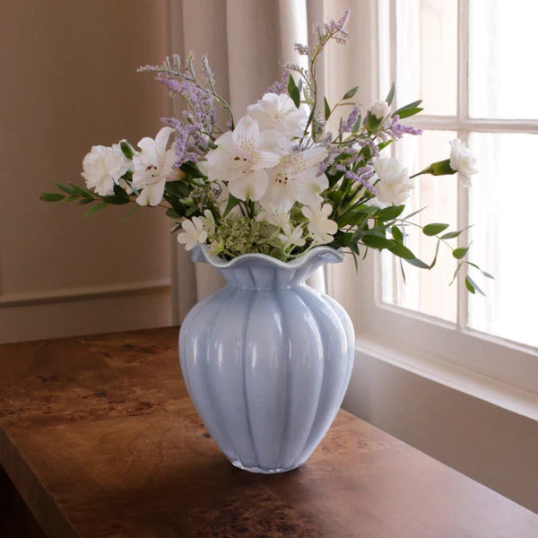 One-of-a-kind hand-blown glass vase in soft blue, featuring artistic interior painting and a smooth, modern shape.