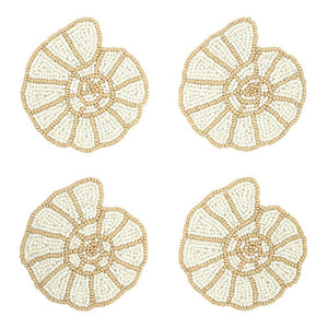 Set of four shell-shaped glass bead coasters arranged on a white background