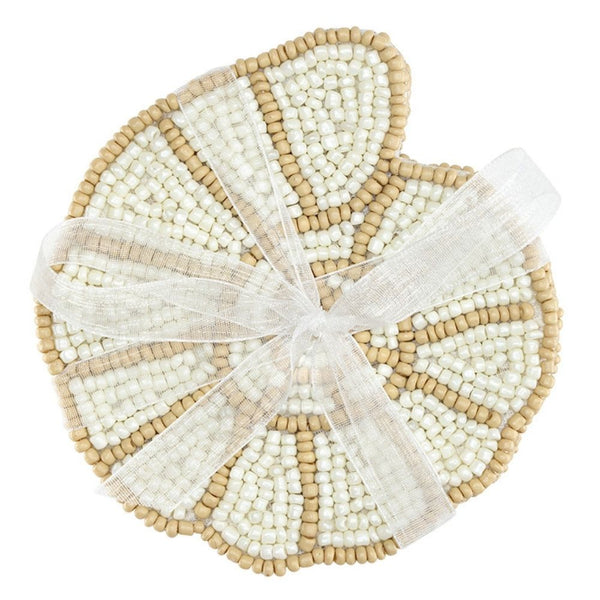 Stack of shell-shaped glass bead coasters in neutral coastal tones