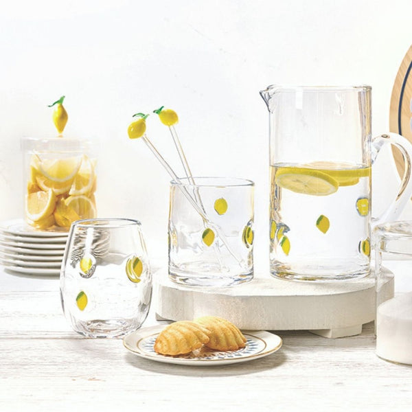 Glass lemon-themed kitchen canister with lid styled with lemon glassware and kitchen decor