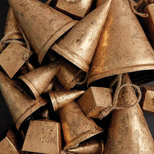 Close-up of rustic iron bell showing rope texture and metal finish