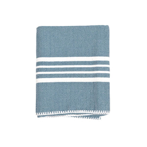 Soft sun-kissed Turkish towel neatly folded, highlighting premium hand-stitched edge