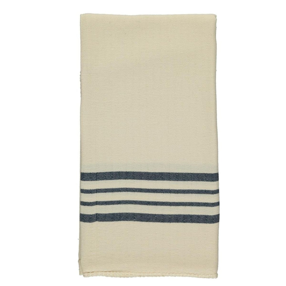 Soft sun-kissed Turkish towel neatly folded, highlighting premium hand-stitched edge
