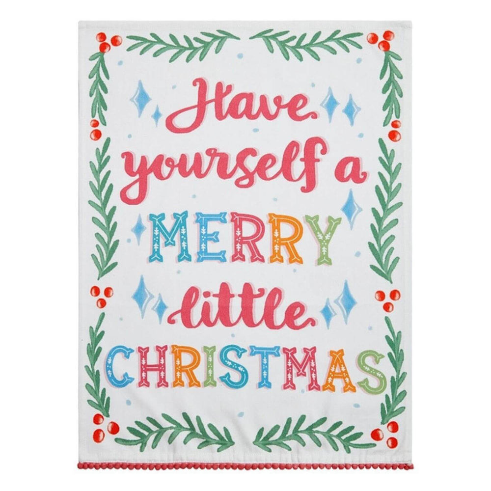 A hand screen-printed cotton flour sack kitchen towel with a whimsical Christmas design and red pompom trim, perfect for adding festive charm to holiday kitchens.