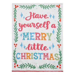 A hand screen-printed cotton flour sack kitchen towel with a whimsical Christmas design and red pompom trim, perfect for adding festive charm to holiday kitchens.