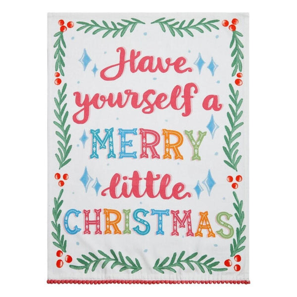 A hand screen-printed cotton flour sack kitchen towel with a whimsical Christmas design and red pompom trim, perfect for adding festive charm to holiday kitchens.