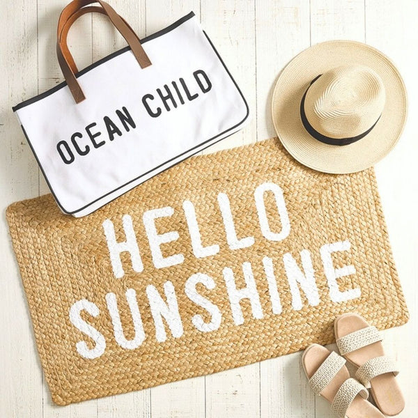 Hello Sunshine jute doormat styled with beach accessories