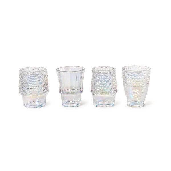 Set of four iridescent fish glasses with embossed design stacked together on a coastal-style table