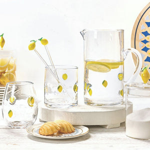Glass lemon-themed kitchen canister with lid styled with lemon glassware and kitchen decor