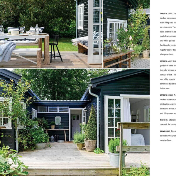 "Living by the Water" Hardcover Book by Sally Hayden, Coastal cabin with a wooden deck, dark exterior walls, and outdoor seating