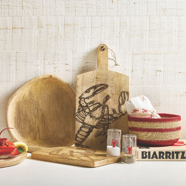 Mango wood serving board with carved lobster design styled with coastal kitchen décor