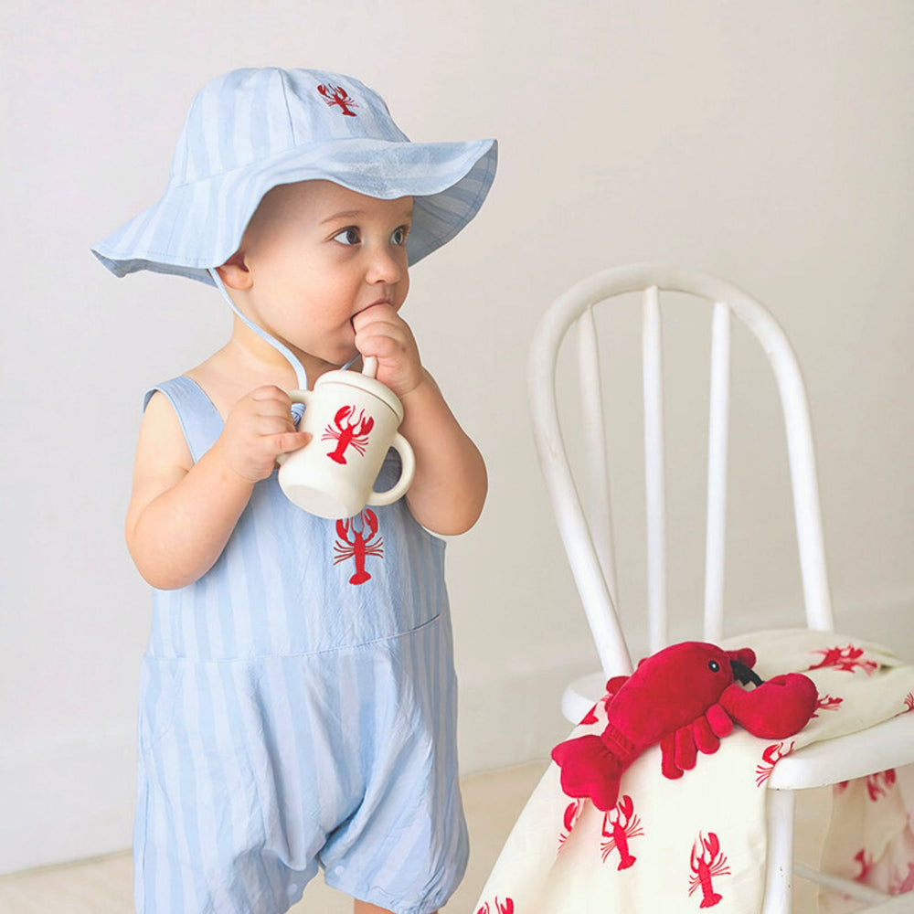 Blue and white striped baby sun hat with red lobster print, blue and white stripes, and chin tie.