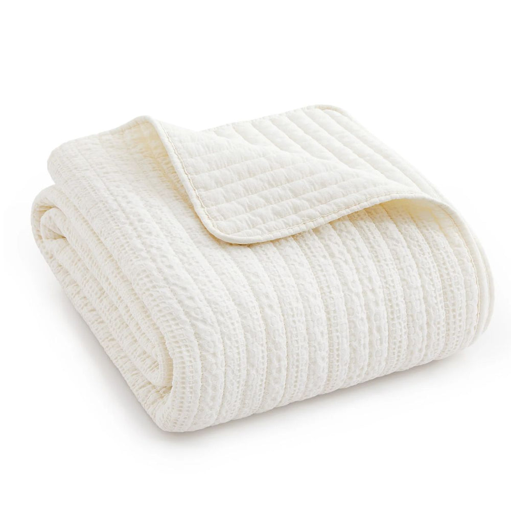 Loden throw blanket with waffle weave design, soft cotton front and back, ideal for cozy home décor.